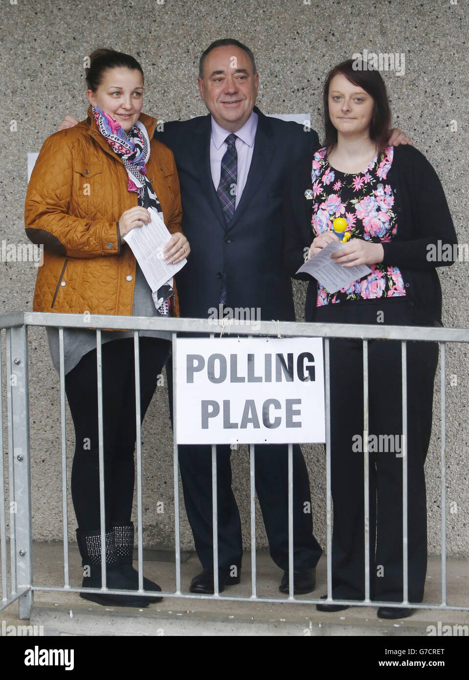 Scottish First Minister Alex Salmond with first time voters Lia Pirie (left) and Natasha McDonald (right) outside Ritchie Hall polling station in Strichen as polls have opened on a historic day for Scotland as voters determine whether the country should remain part of the United Kingdom. Stock Photo