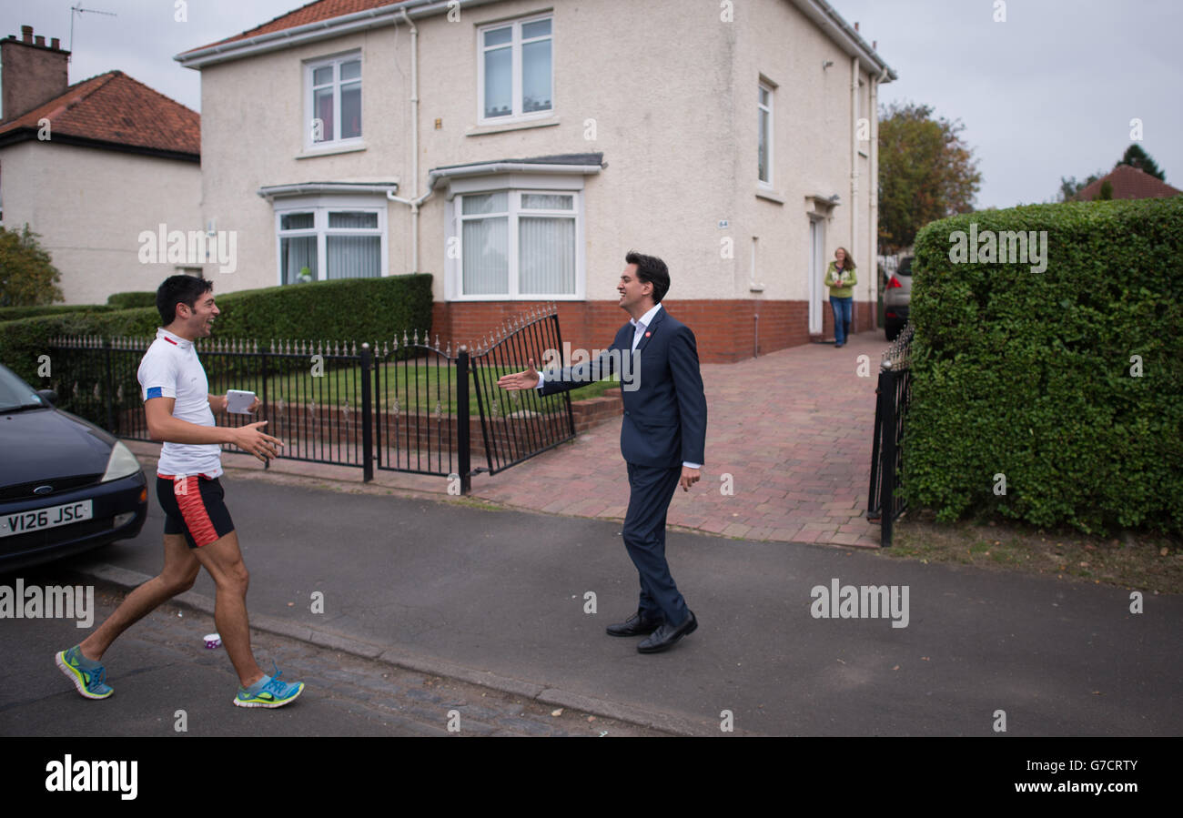 Labour leader Ed Miliband (right)canvasses voters in the Knightswood area of Glasgow during a historic day for Scotland as voters determine whether the country should remain part of the United Kingdom. Stock Photo