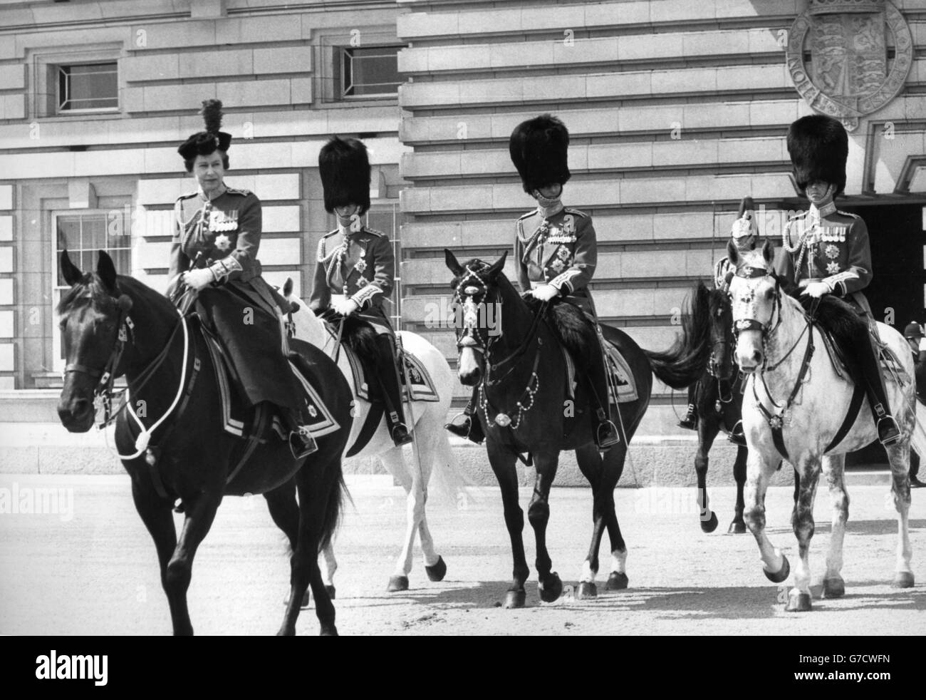 Queen Elizabeth II, in the uniform of Colonel-in-Chief Coldstream Guards, rides side-saddle on the black mare Burmese as she leaves Buckingham Palace to take the salute at the Trooping the Colour ceremony on Horse Guards Parade. Accompanying her are (l-r) Prince Charles, Prince Philip and the Duke of Kent. *Scan from print. Hi-res version available on request* Stock Photo
