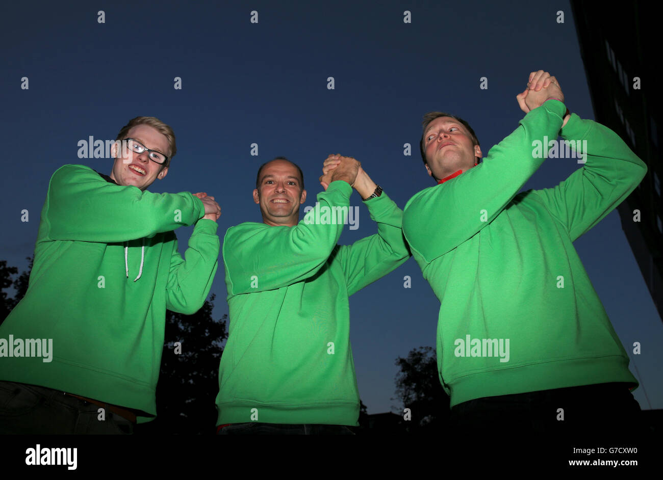 Nottingham Forest fans Simon Fotheringham, James Howley and Robin Campbell outside the ground pay tribute to former manager Brian Clough by wearing green jumpers during the Capital One Cup Third Round match at White Hart Lane, London. Stock Photo