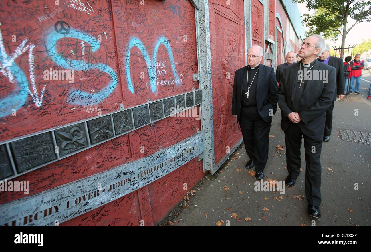 (left to right) Archbishop of Armagh Richard Clarke and Archbishop of Canterbury Justin Welby pay a visit a to the peace wall in Cupar Way, in west Belfast. Stock Photo