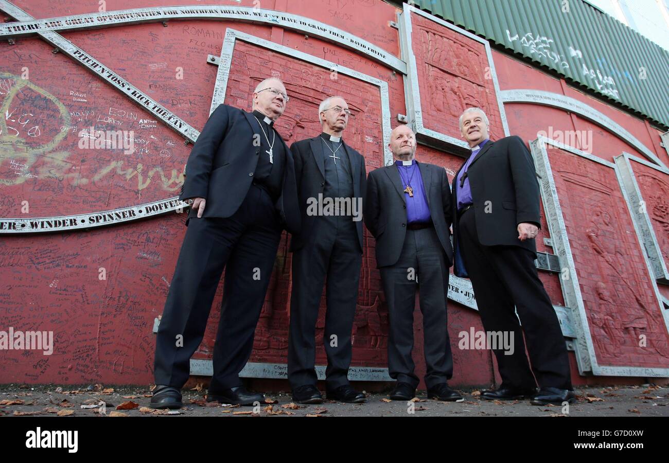 (left to right) Archbishop of Armagh Richard Clarke, Archbishop of Canterbury Justin Welby, Bishop Alan Abernethy and Archbishop of Dublin Michael Jackson all pay a visit a to the peace wall in Cupar Way, in west Belfast. Stock Photo
