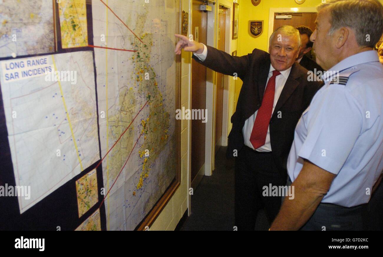 Rt Hon Adam Ingram MP, Minister of State for the Armed Forces, with acting office commanding Flight Lt John Davies (right) of the Aeronautical rescue centre, viewing a map showing where all rescues have taken place throughout Britain. He will visit RAF Kinloss in Moray, before travelling to Inverness to meet David Stewart, MP for Inverness East, Nairn and Lochaber, retired soldiers and community leaders to discuss future army structure issues. Stock Photo