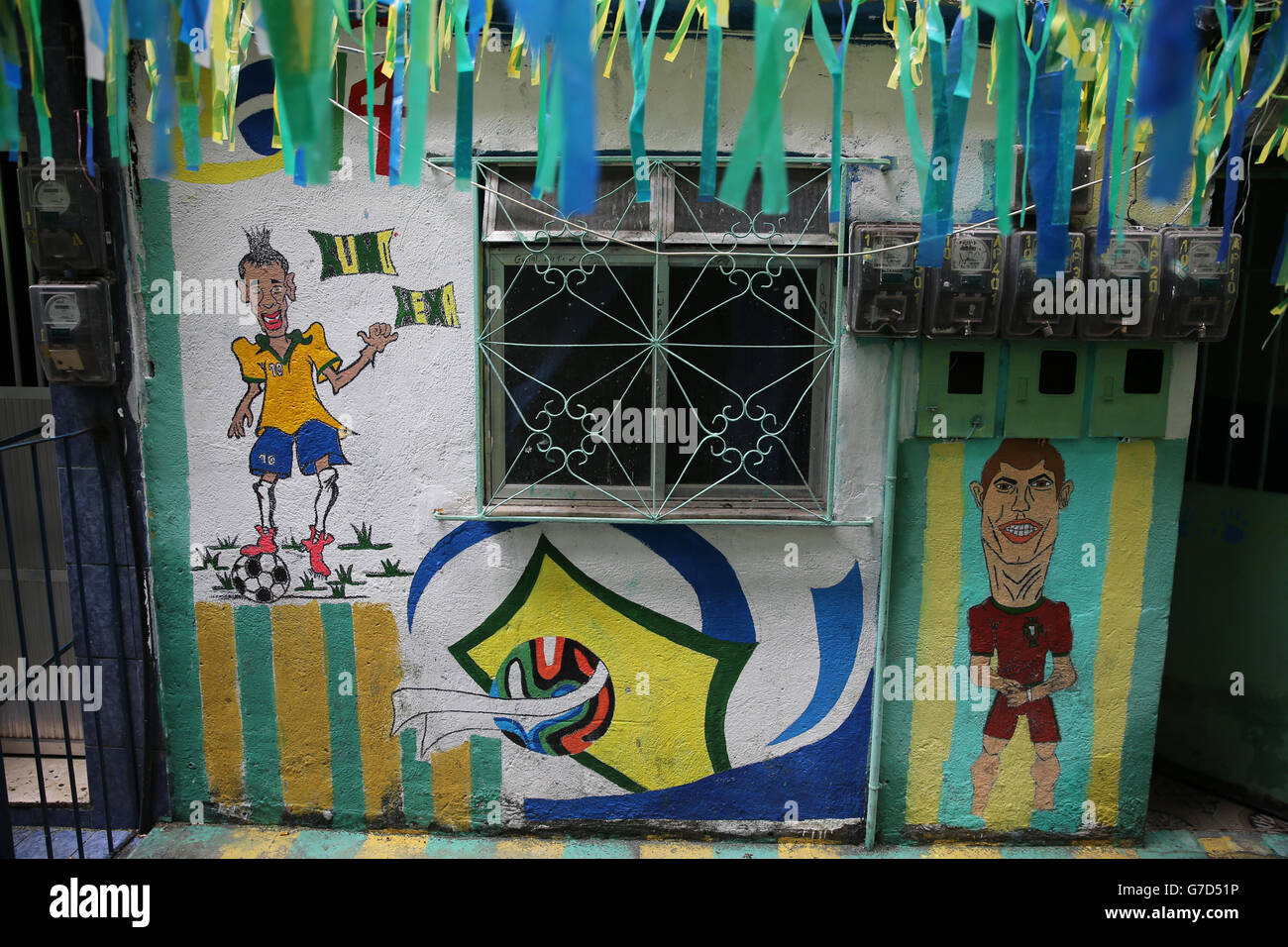 Rio De Janeiro, Brazil views of daily life in Rocinha Favela on the day of Brazil playing in the third place play off in World Cup 2014 finals with art work of Brazil's Neymar and Portual's Ronaldo Stock Photo