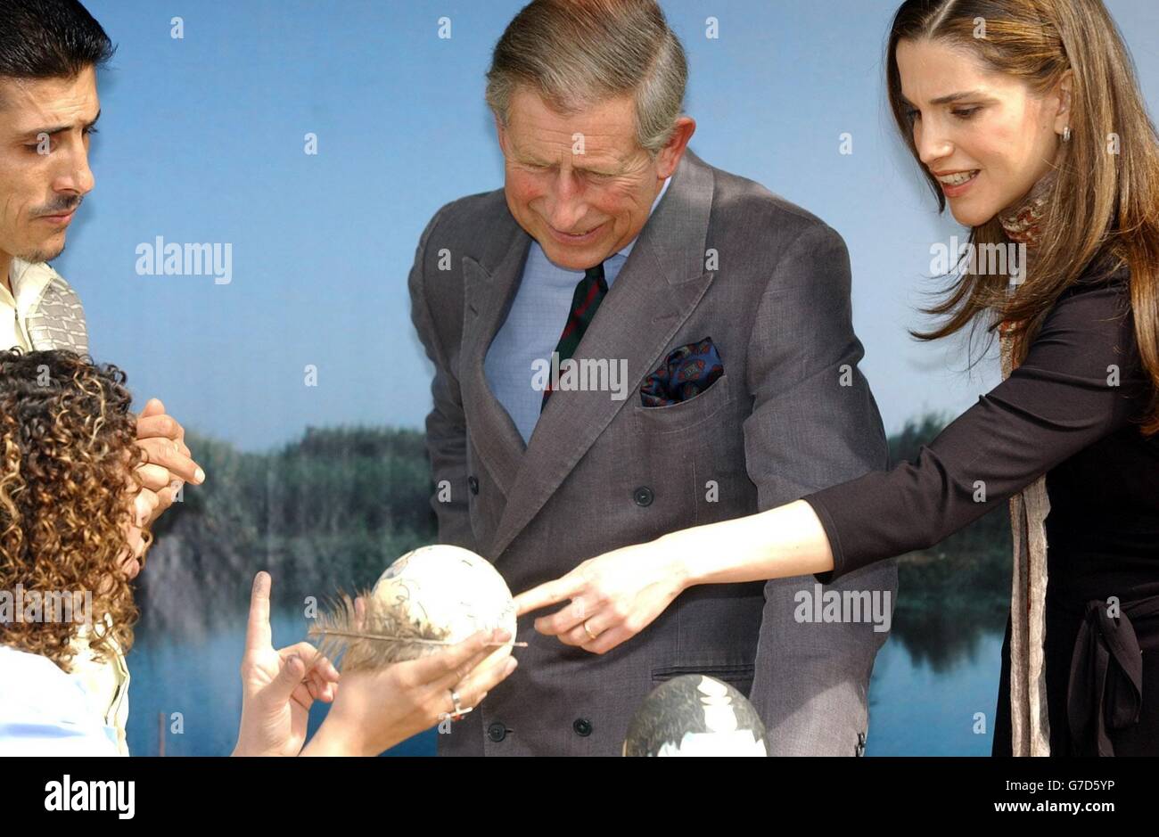 Britain's Prince Charles, the Prince of Wales, (centre) and Jordan's Queen Rania look at painted eggs during a visit to the Ajloun Nature Reserve in Jordan. Stock Photo