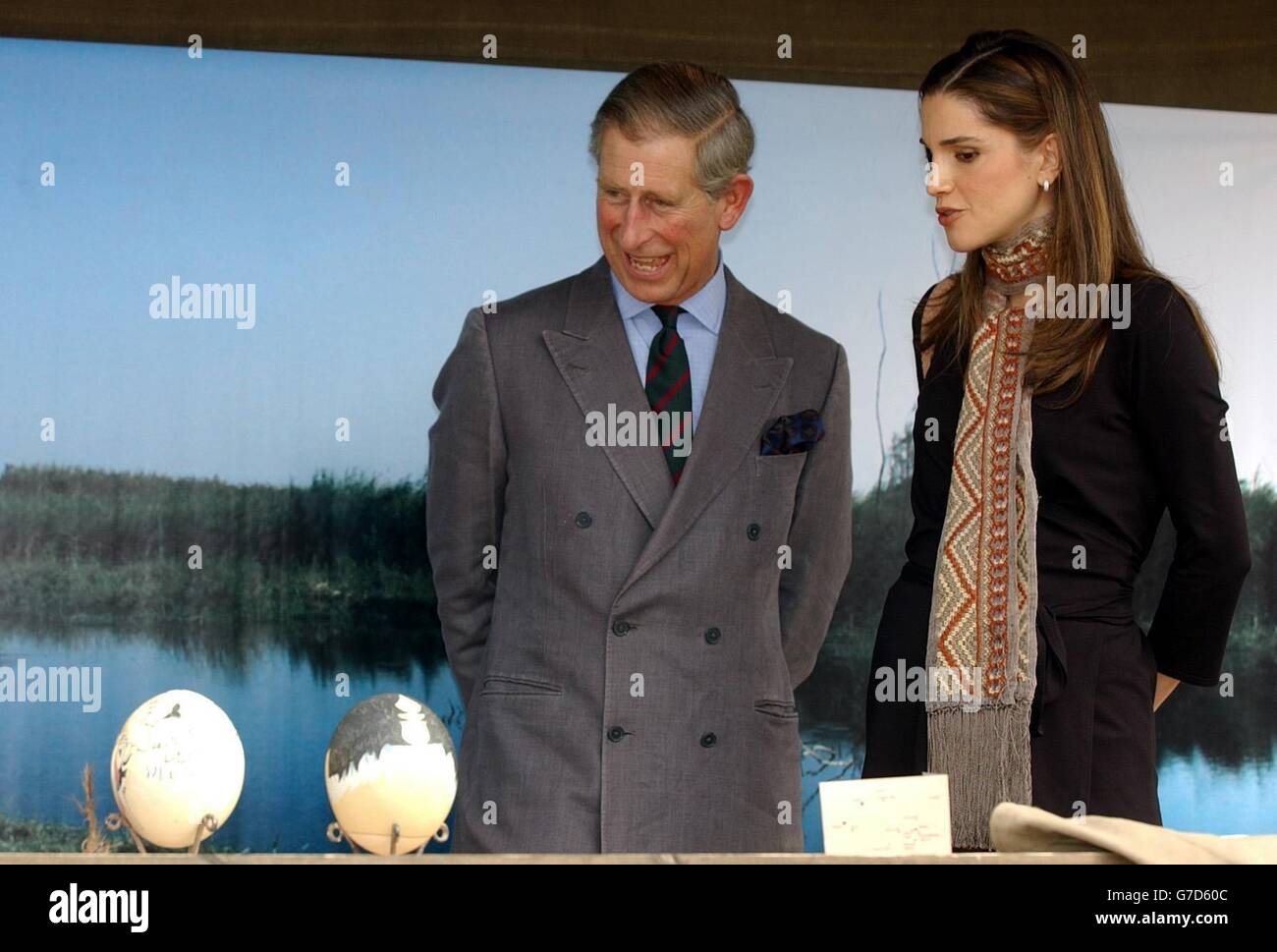Britain's Prince Charles, the Prince of Wales, (left) laughs with Jordan's Queen Rania as they look at painted eggs at the Ajloun Nature Reserve in Jordan. Stock Photo