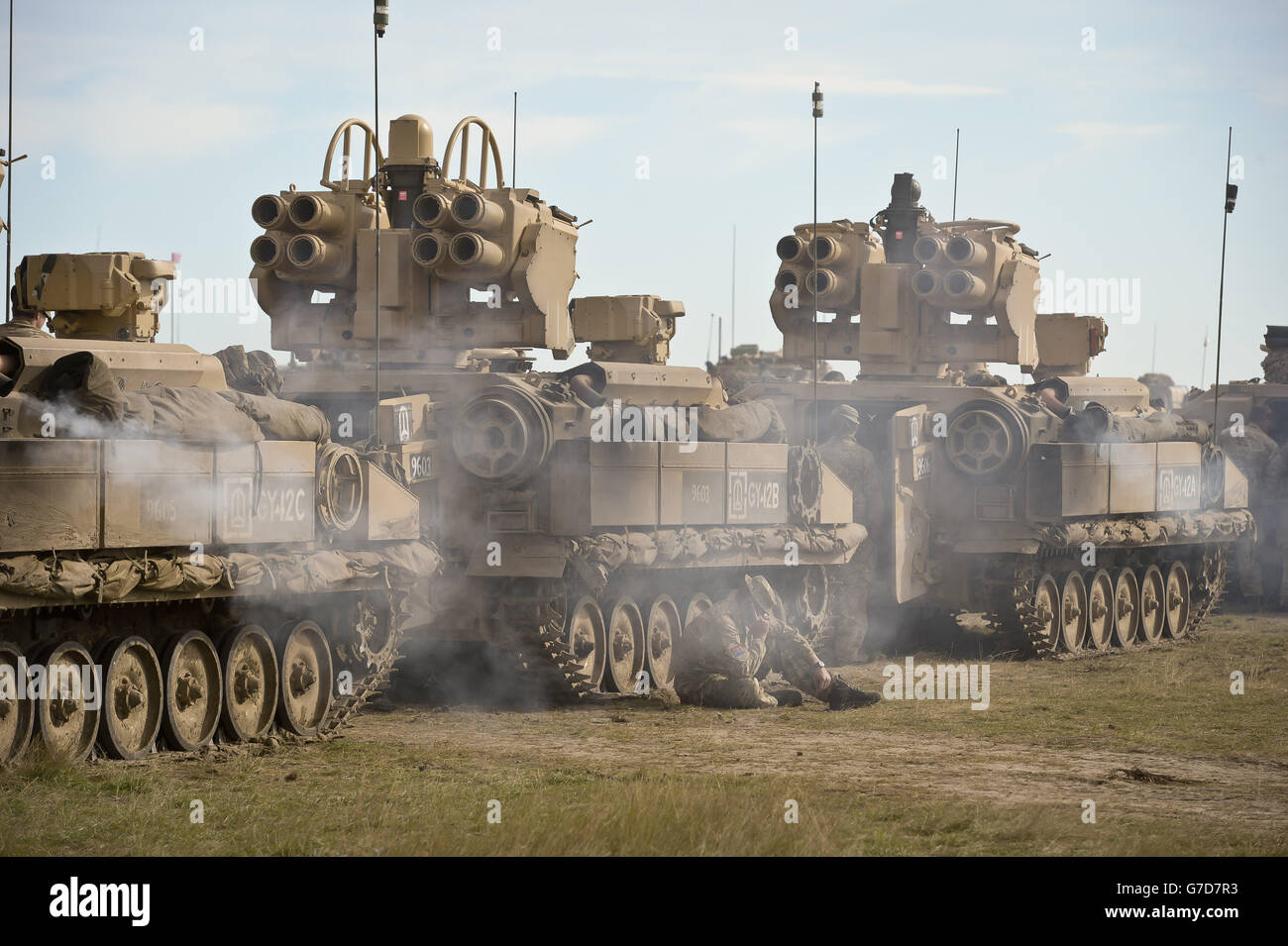 Previously unreleased picture dated 20/09/14 of a soldier sitting beside an armoured vehicle column as they ready to move out during exercise Prarie Storm, about 1,000 soldiers are training on a mock battlefield in Calgary, Canada, as part of the British Army's biggest training exercise of the year. Stock Photo