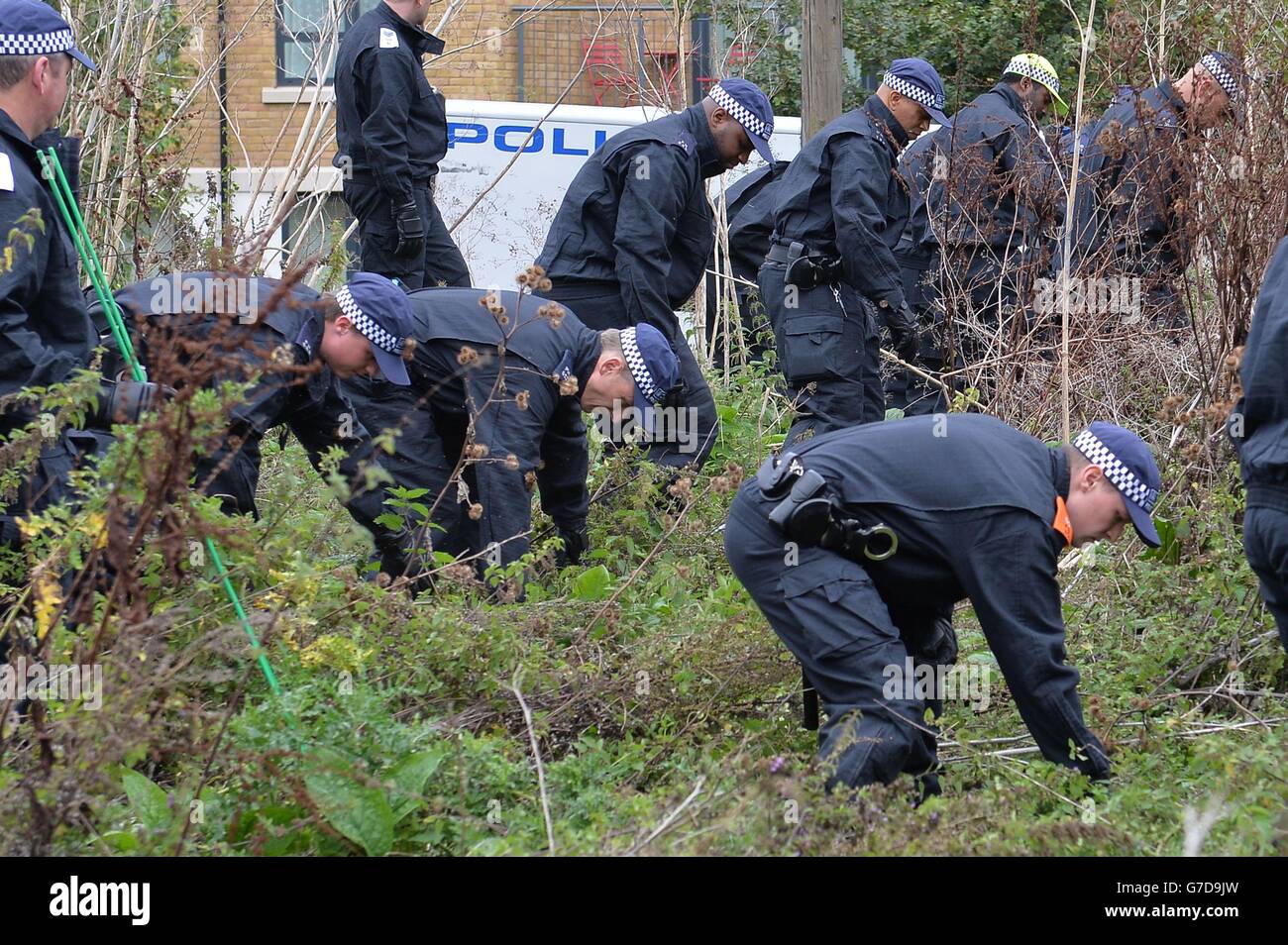 Police search a section of wasteland between the river Brent and Elthorne Park near to Trumpers