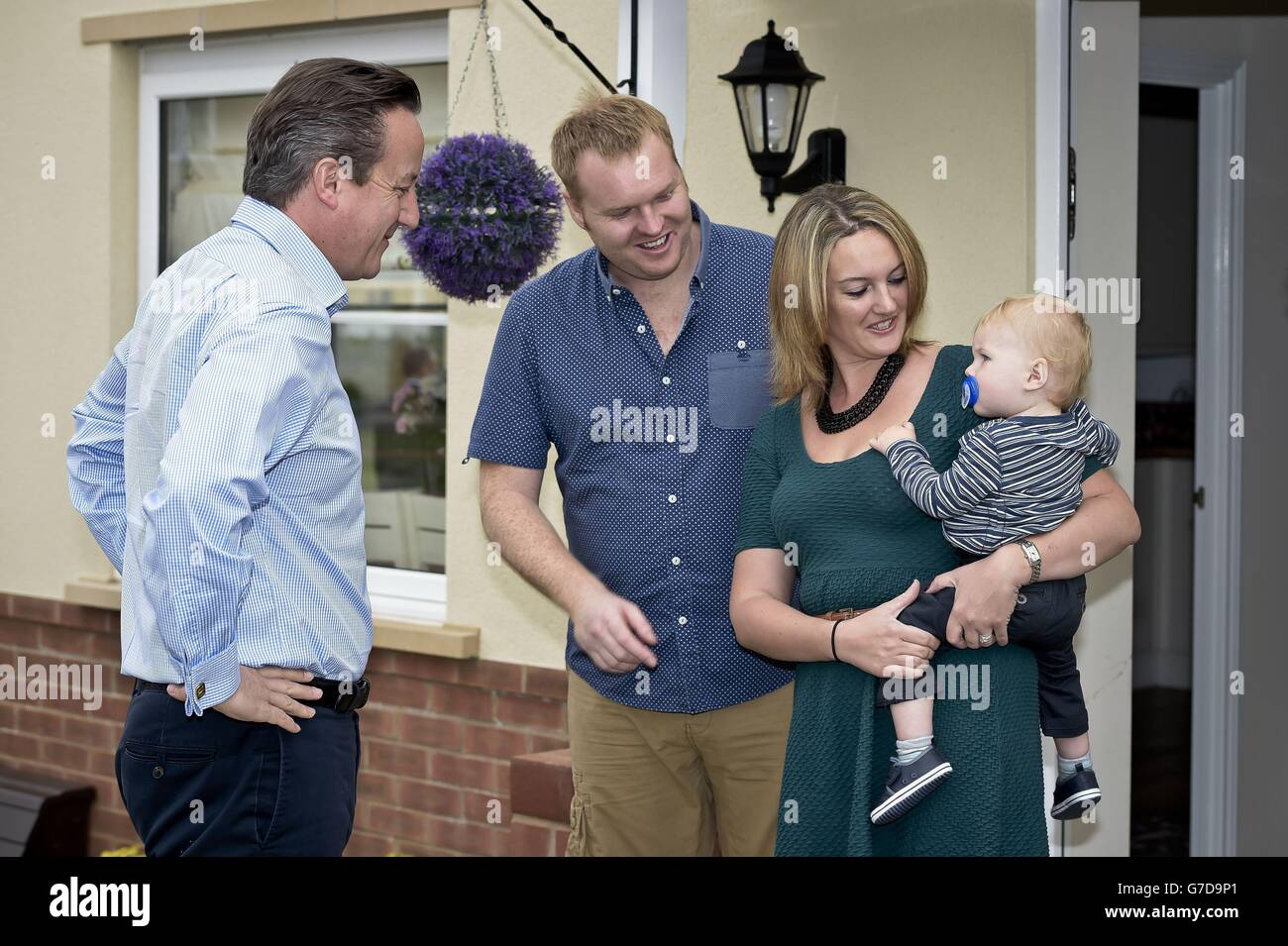 Prime Minister David Cameron meets Barry and Samantha McBeth and their one year old Alfie during a visit to the new Taylor Wimpy Great Western Park housing estate, Didcot, Oxfordshire ahead of the start of the Conservative Party Conference. Stock Photo