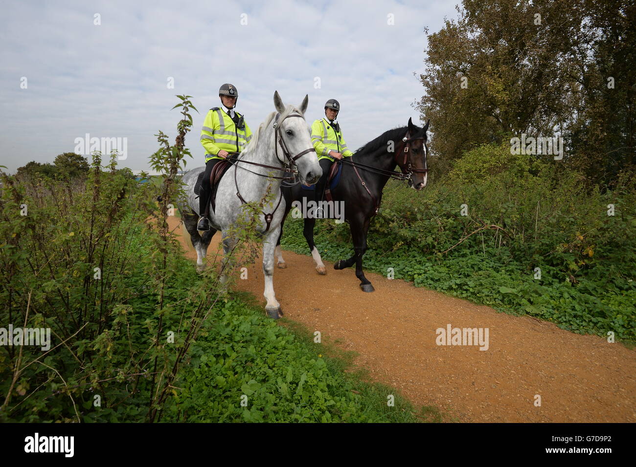 Horse mounted police search a section of wasteland between the river Brent and Elthorne Park