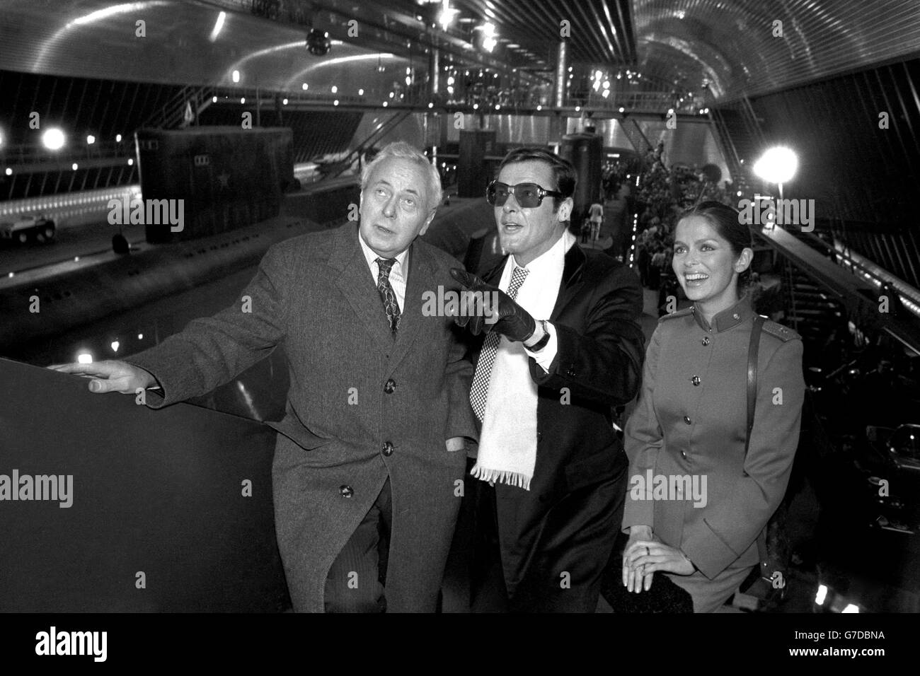 Sir Harold Wilson attends the opening of the 'largest film stage in the world' at Pinewood Studios. He is shown round by actor Roger Moore and his co-star Barbara Bach, who appear together in The Spy Who Loved Me. The film stage was created for the James Bond film and will be used for major scenes featuring a super tanker and submarines. Stock Photo