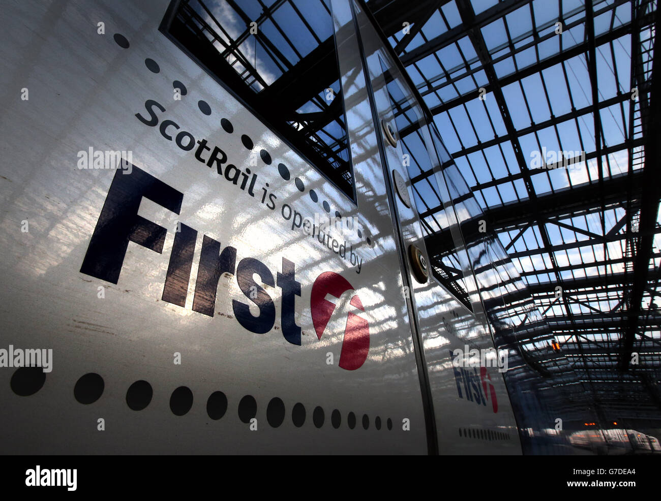 The roof of Waverley Station is reflected in the doors of a First Scotrail train as the franchise to run Scotland's trains for the next decade has been awarded to Dutch rail operator Abellio. Stock Photo