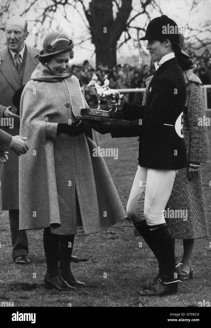 Queen Elizabeth II presents the Whitbread Trophy to Jane Holderness-Roddam after her win on Warrior in the three-day event at the Badminton Horse Trials. Behind the Queen is the Duke of Beaufort. Stock Photo