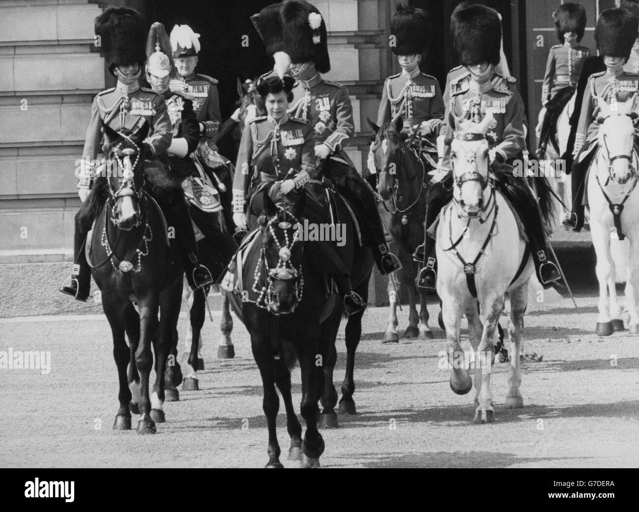 Queen Elizabeth II, wearing the uniform of the Grenadier Guards, leaves Buckingham Palace to take the salute at the Trooping of the Colour ceremony on Horse Guards Parade. Accompanying her are (l-r) the Duke of Edinburgh, Prince Charles, and the Duke of Kent. Stock Photo