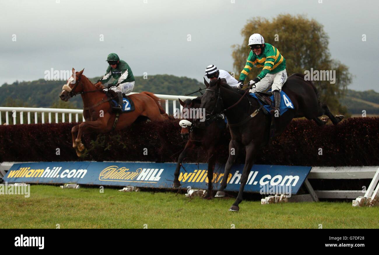 Eventual winner Bullet Street ridden by Paul Moloney (left) jumps the last with The Bear Trap ridden by AP McCoy (right) on their way to victory in the Racing UK Novices' Limited Handicap Chase at Ludlow Racecourse. Stock Photo