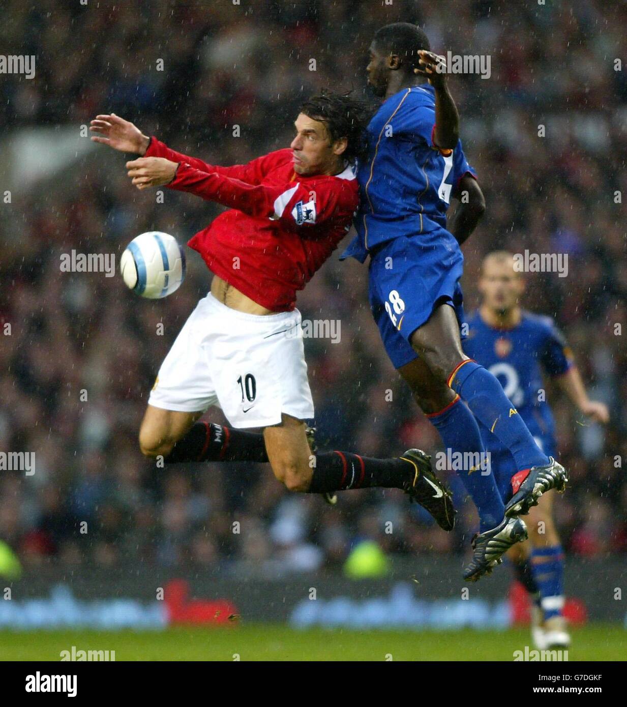Ruud Van Nistelrooy of Manchester United battles with Arsenal's Kolo Toure during the Barclays Premiership match at Old Trafford, Manchester. Stock Photo