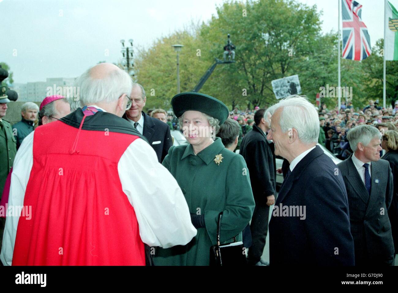 Queen Elizabeth II and the Duke of Edinburgh greet Church leaders as they arrive at the Kreuzekirche in Dresden. She was booed and had eggs thrown at her, whilst protesters held banners. Stock Photo