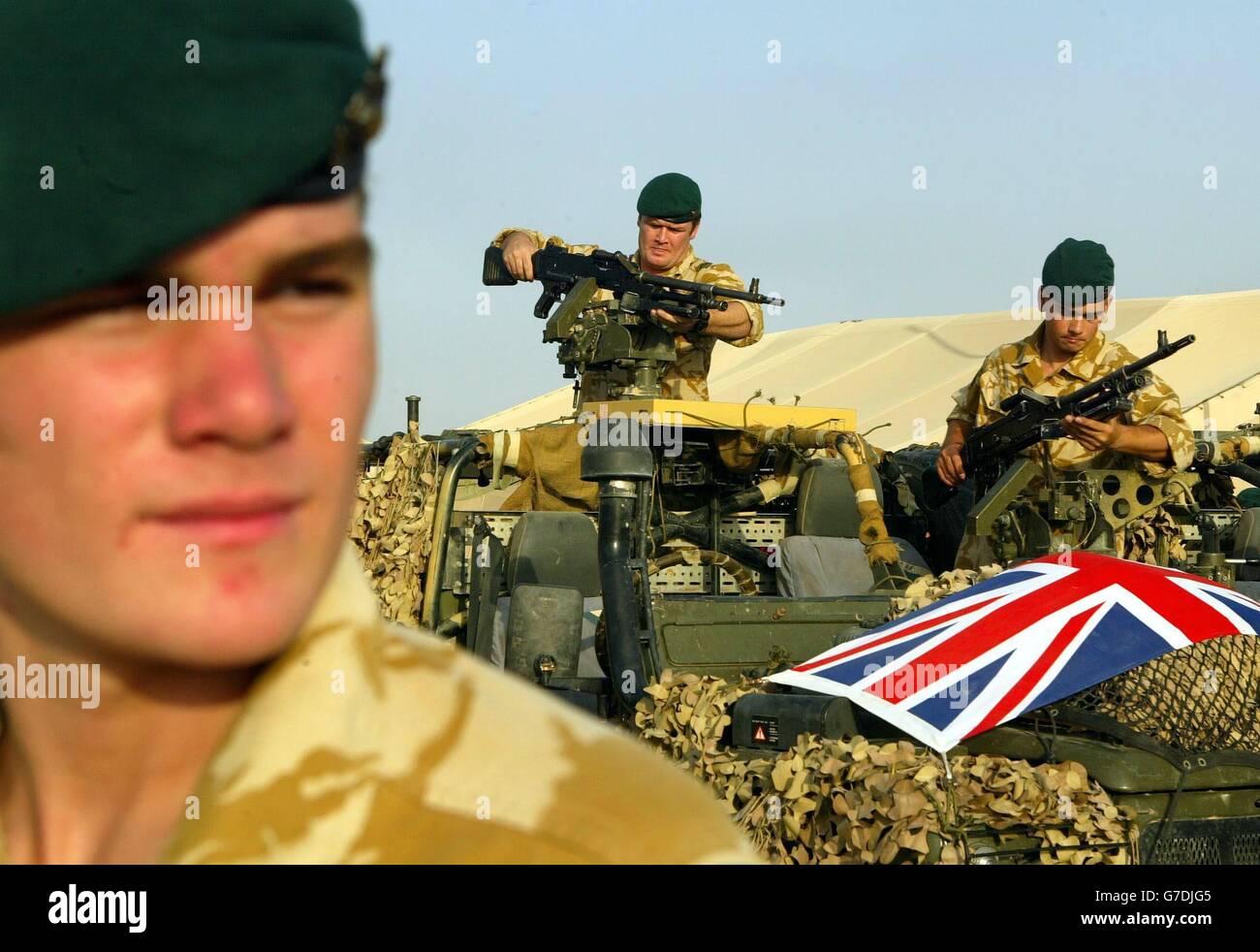 Craig Jones from Cardiff, a marine based at Shaibah Logistical Base With 40 Commando (home base Summerset, UK) looks on, as other members of his company get prepared to move out to help give support to the Black Watch at Camp Dogwood, 20 miles west of Baghdad. The 40 Commando Royal Marines is part of the Black Watch battle group, which will be operating in the area where the US 24 Marine Expeditionary Unit has been deployed. Stock Photo