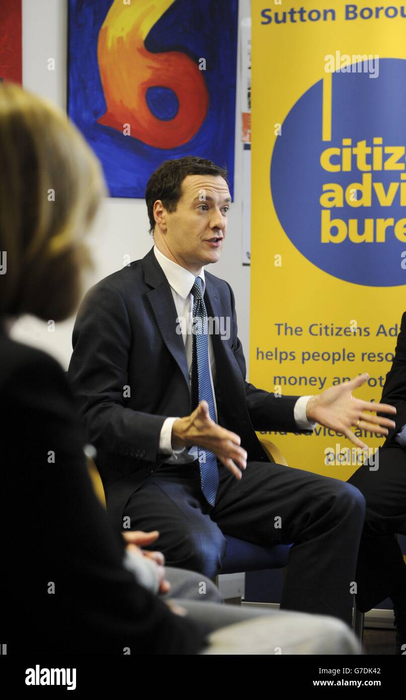 Chancellor George Osborne talks to staff and volunteers during a visit to  the Citizens Advice Bureau in Sutton, south west London where he was making  an announcement on pensions guidance Stock Photo -