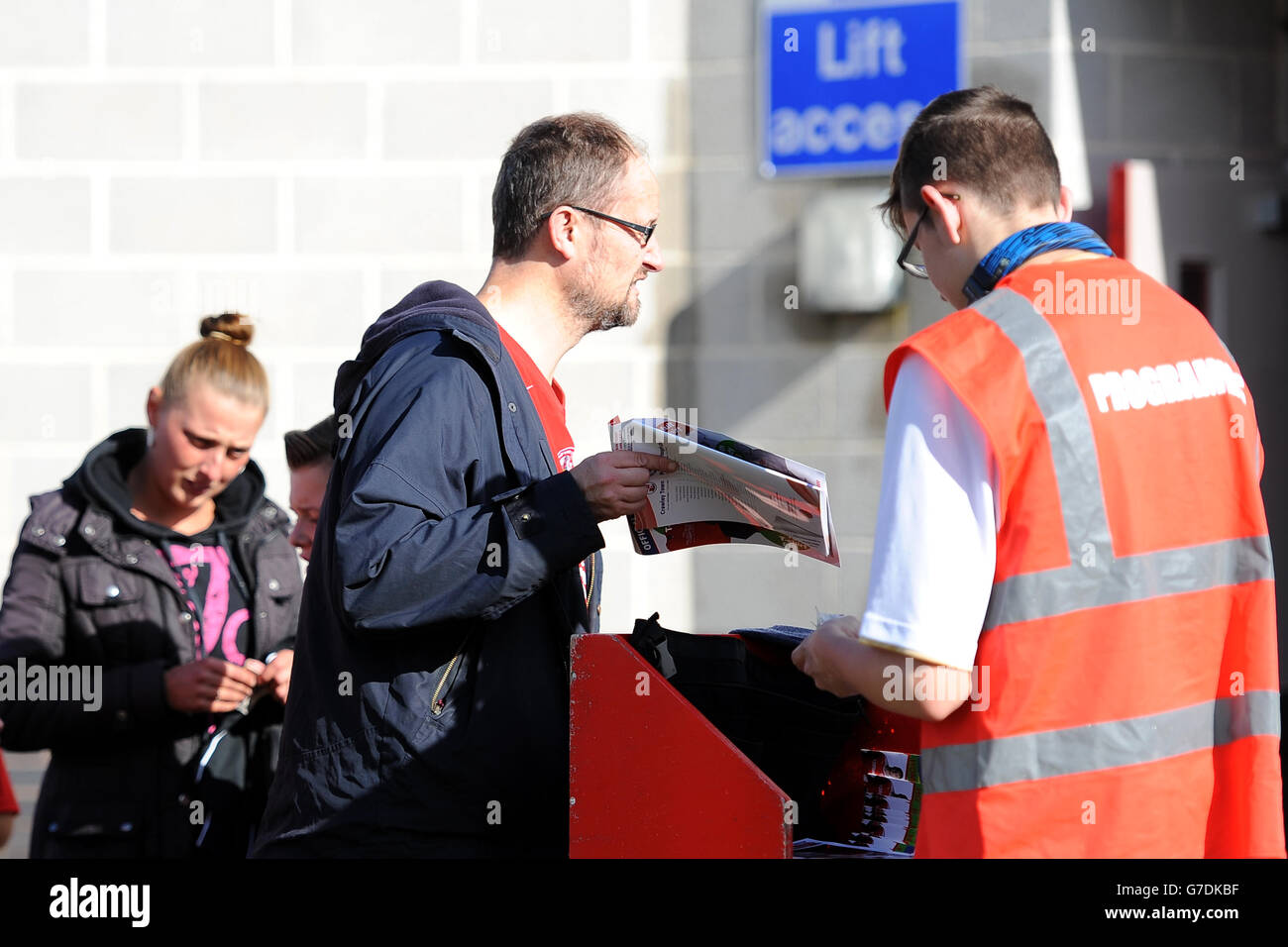 A vendor sells match day programmes outside the Checkatrade.com Stadium ...