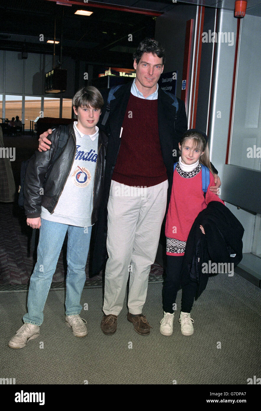 American actor Christopher Reeve, who played Superman, whith his two children Matthew and Alexandra at Heathrow Airport leaving to spend Christmas in New York. 11/10/04: Mr Reeve has died at the age of 52 after he fell into a coma on Saturday and went into cardiac arrest while at his New York home, he then died on Sunday, his publicist Wesley Combs has revealed. Reeve was paralysed from the shoulders down after a riding accident in 1995. Stock Photo
