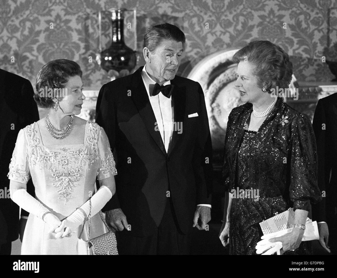 Left to right: Queen Elizabeth II, American President Ronald Reagan and British Prime Minister Margaret Thatcher at Buckingham Palace when they attended a special banquet hosted by the Queen following the London Economic Summit. Stock Photo
