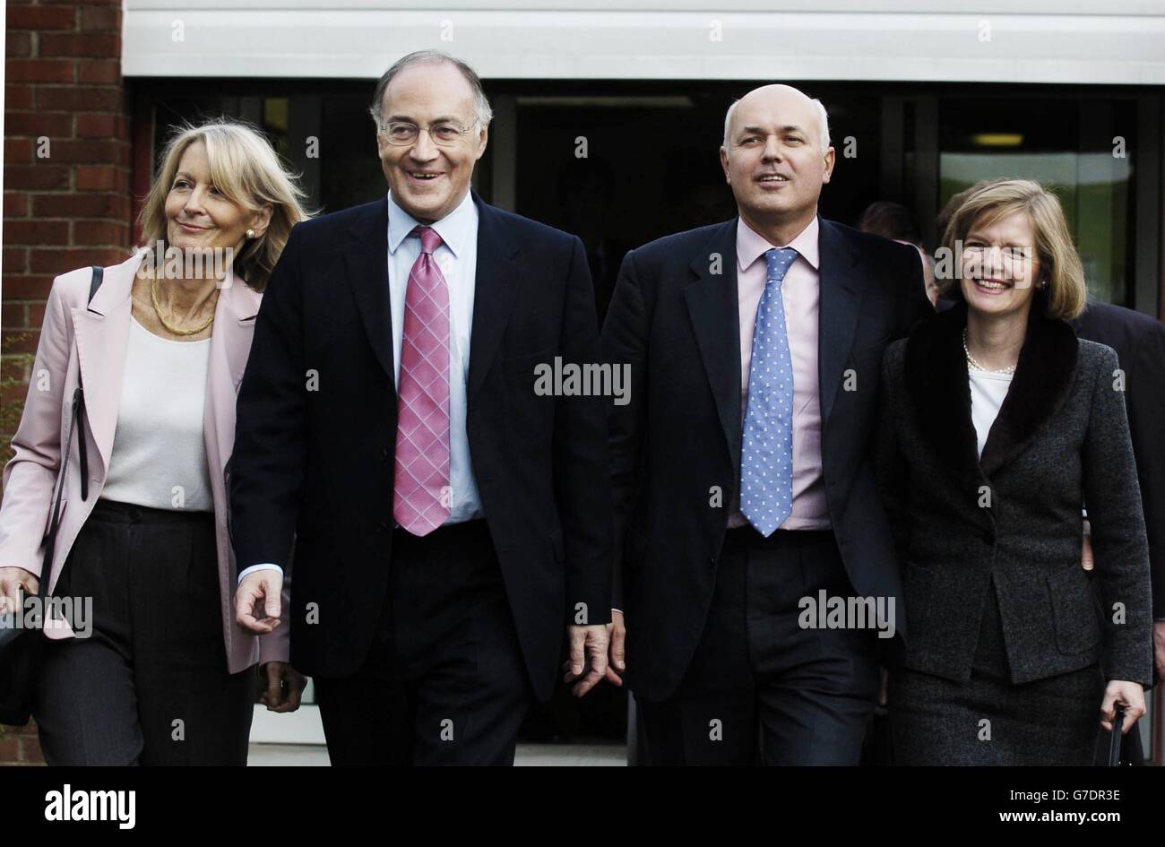 Leader of the Conservative party Michael Howard (left) and his wife Sandra depart with former leader Iain Duncan Smith and his wife Betsy after a tour of the Pollock Community centre in Glasgow. Stock Photo