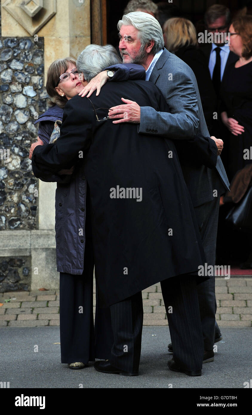 (left to right) Pauline Collins, Tom Conti and John Alderton hug each other as they leave following the funeral of Lynsey de Paul in the South Chapel at Hendon Cemetery, north London. Stock Photo