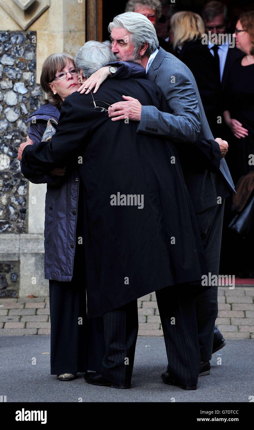 (left to right) Pauline Collins, Tom Conti and John Alderton hug each other as they leave following the funeral of Lynsey de Paul in the South Chapel at Hendon Cemetery, north London. Stock Photo