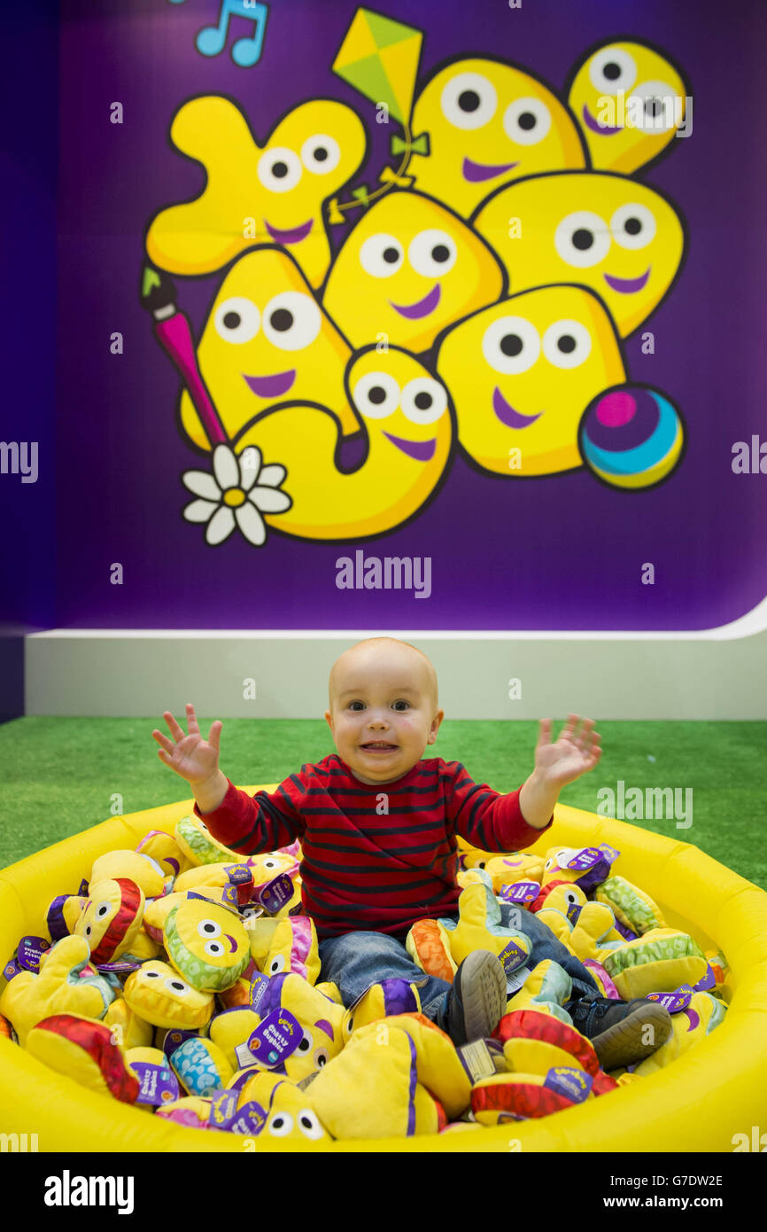 Sebastian Smith, aged 16 months, plays with the new CBeebies Chatty Bugbies toy range during the Brand Licensing Show at Olympia London. Stock Photo