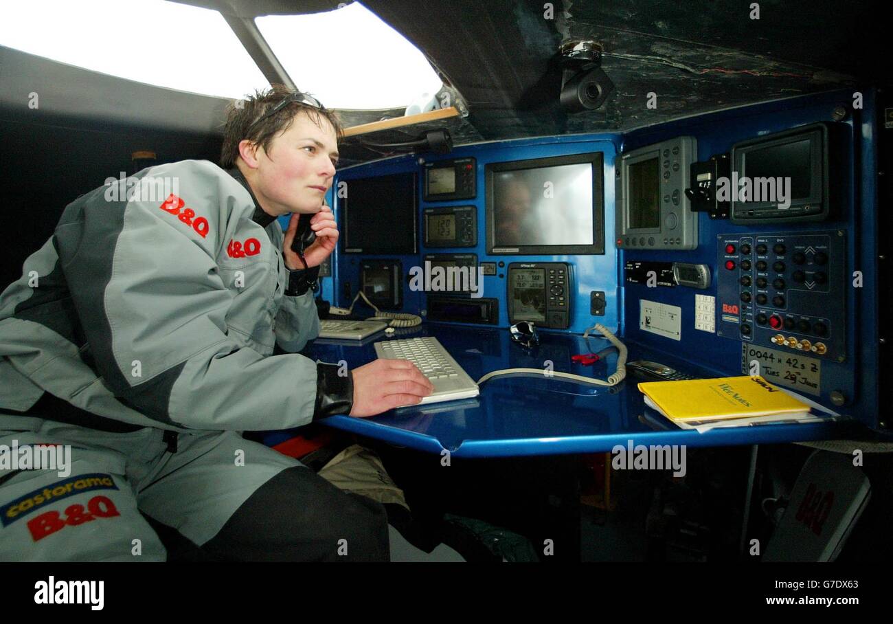 Round-the-world yachtswoman Ellen MacArthur at work in the navigational station aboard her 75ft triamaran B&Q in Lorient, France. The boat will be her home for 70 days when she hopes to become only the second person ever to sail a multi-hulled yacht around the globe, non-stop in November. Stock Photo
