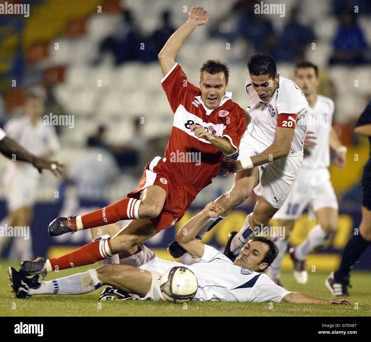 Middlesbrough's Szilard Nemeth (left) is tackled by by Egaleo defenders Georgios Alexopoulos (floor) and Ioannis Skopelitis (right) during the UEFA Cup Group E match at the Aigaleo Municipal Stadium, Athens. Stock Photo