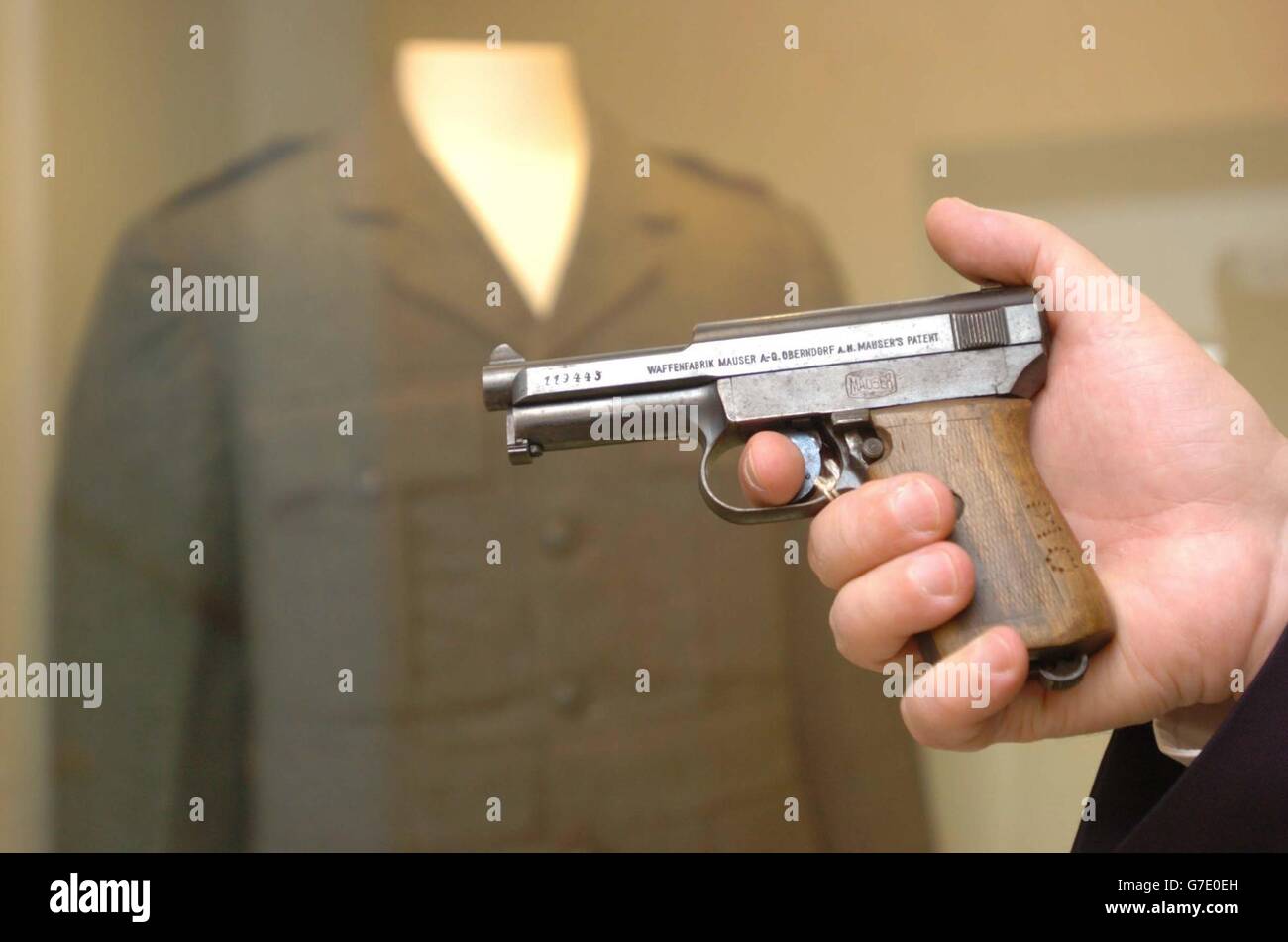 A Mauser model 1911 automatic pistol, which belonged to Irish political figure, Michael Collins is displayed by Dr Pat Wallace, Director of the National Museum of Ireland, at Collins Barracks, Dublin, Ireland. The initials 'MC' can be seen at the base of the wooden grip and it will form part of a new Michael Collins memorabilia exhibit that also includes a sword, a uniform and the pen allegedly used to sign the Anglo/Irish Treaty. Stock Photo