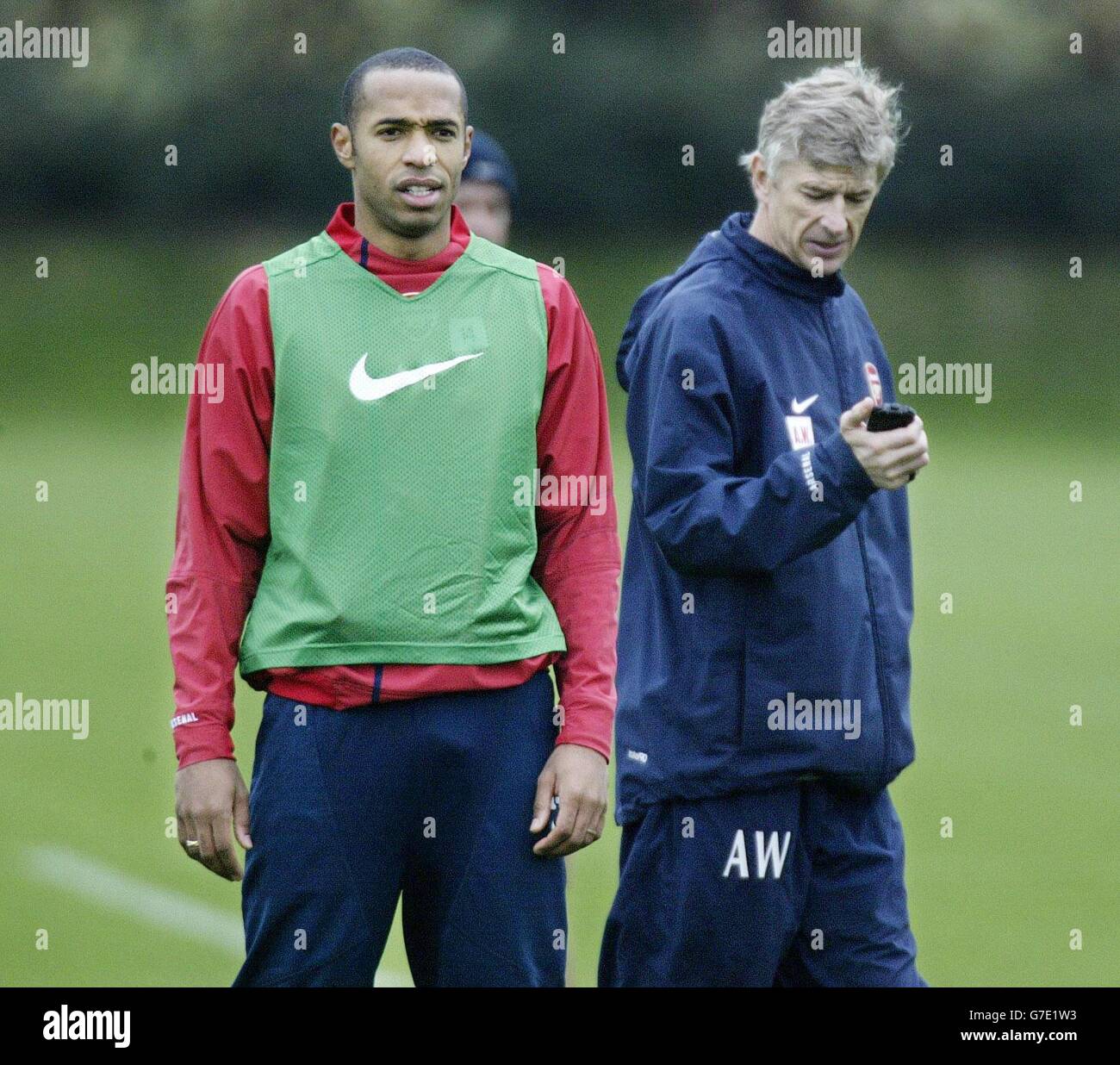 Arsenal's Thierry Henry (left) watches training with his manager Arsene