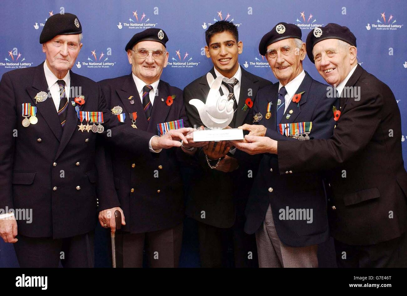 Olympic boxing silver medalist Amir Khan with (left-right) Ray Viney, Ron Jones, Laurie Symes and Bernard Poole with their National Lottery Helping Hands National Hero Award, during their 10th Birthday celebrations, at the Tate Modern in central London. Stock Photo
