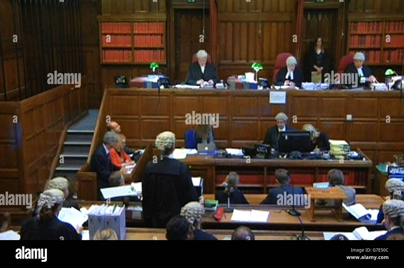 A still taken from a video feed of (left to right, back row) Mr Justice Turner, Lord Justice Treacy and Judge Michael Pert QC during the filming of Max Clifford's appeal hearing in the Court of Appeal, London, as the three Court of Appeal judges said they would give their decision in his case at a later date after they heard argument on his behalf against his 'too long' prison term. Stock Photo
