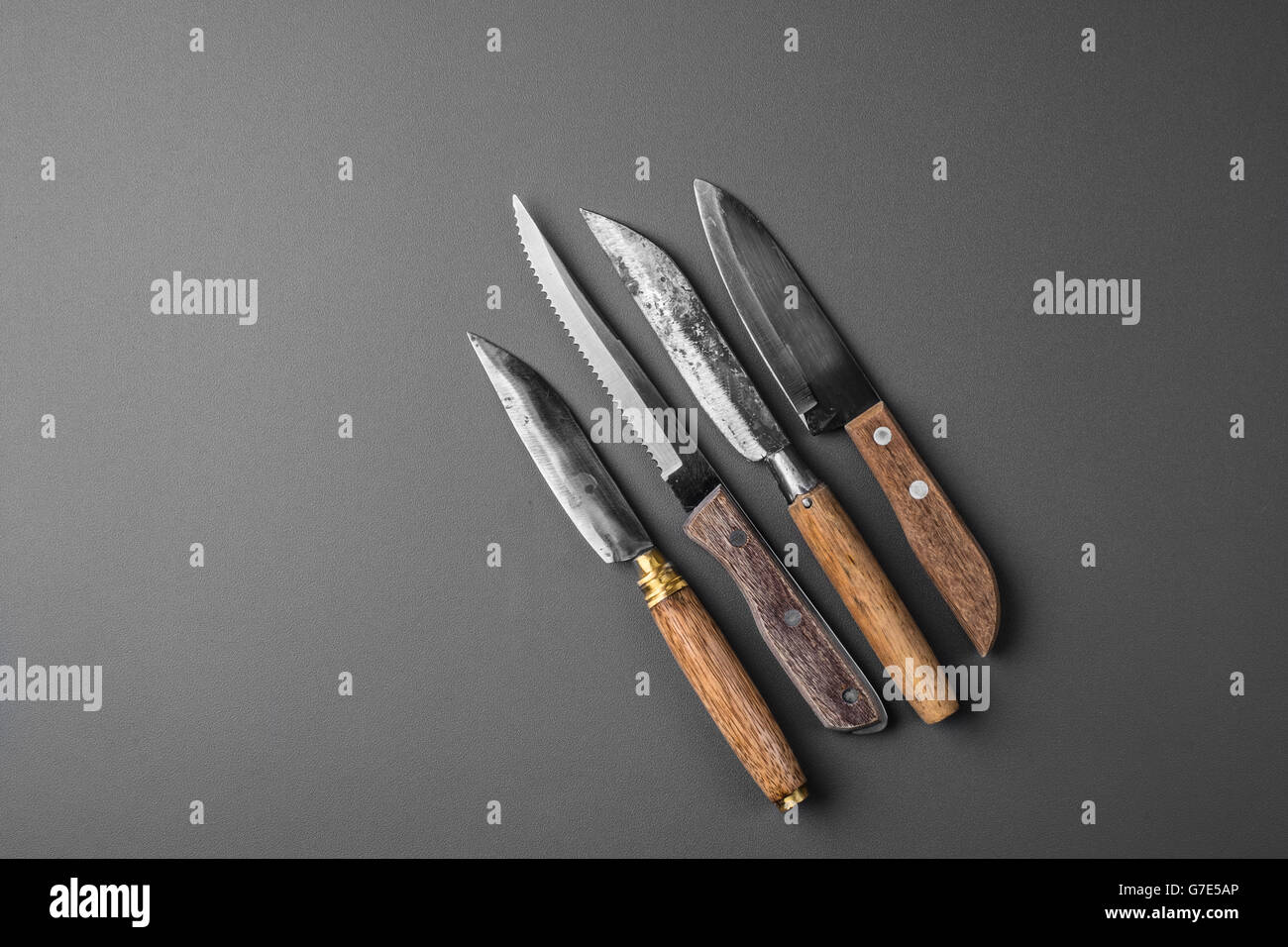 collection of various kitchen knives on a grey background Stock Photo
