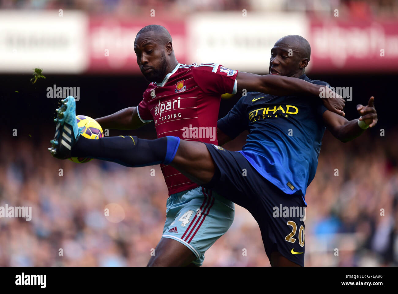 West Ham United's Carlton Cole (left) and Manchester City's Eliaquim Mangala (right) battle for the ball in the air Stock Photo