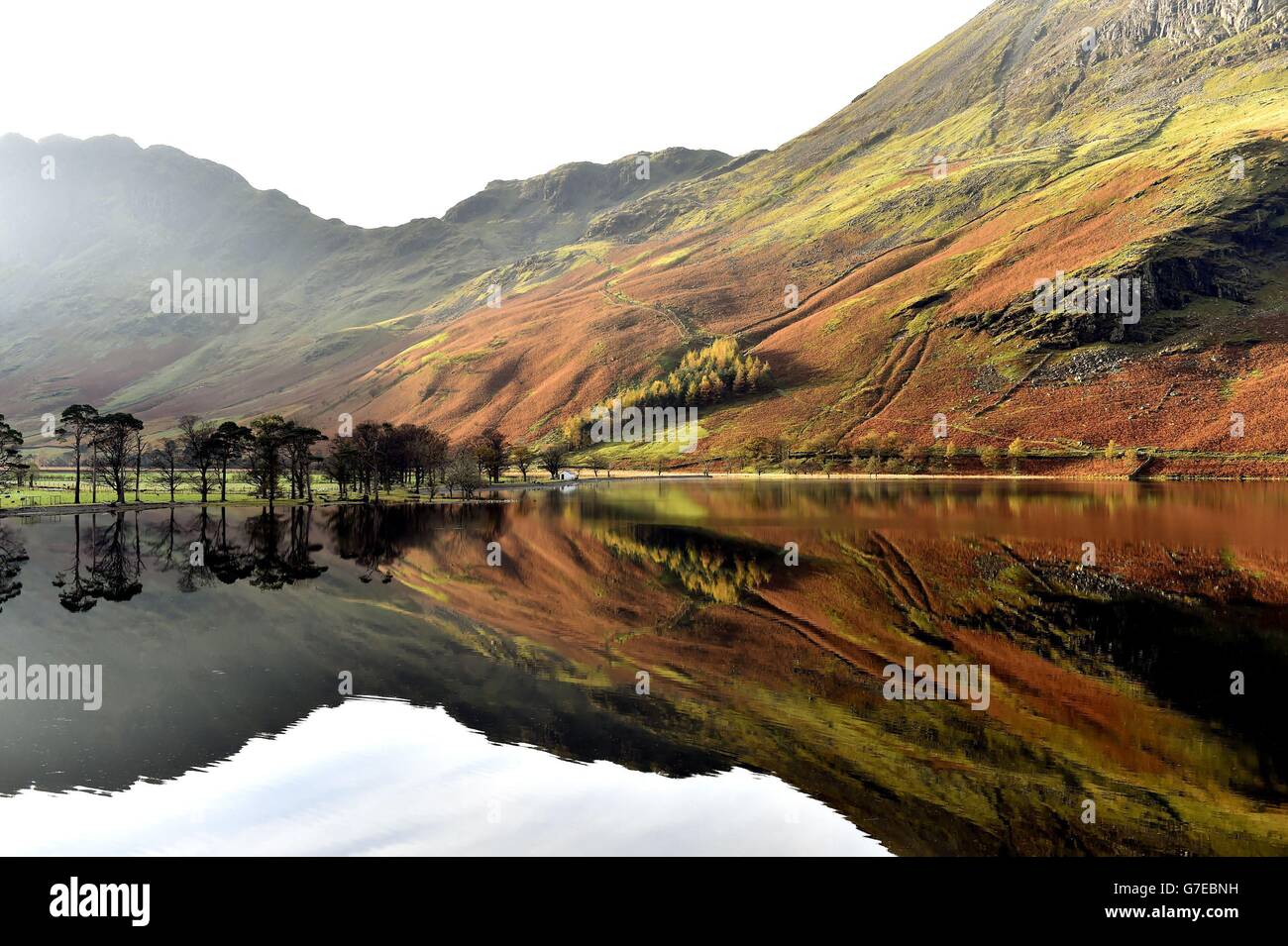 Autumn reflections are seen on Lake Buttermere in the Lake District in Cumbria, as the