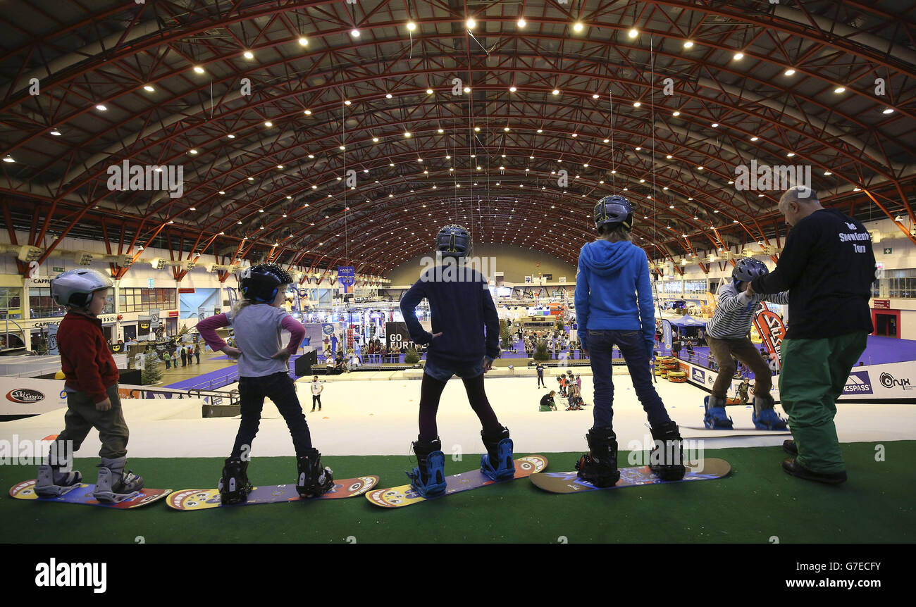 Children having a snowboard lesson on the dry ski slope at the Ski and