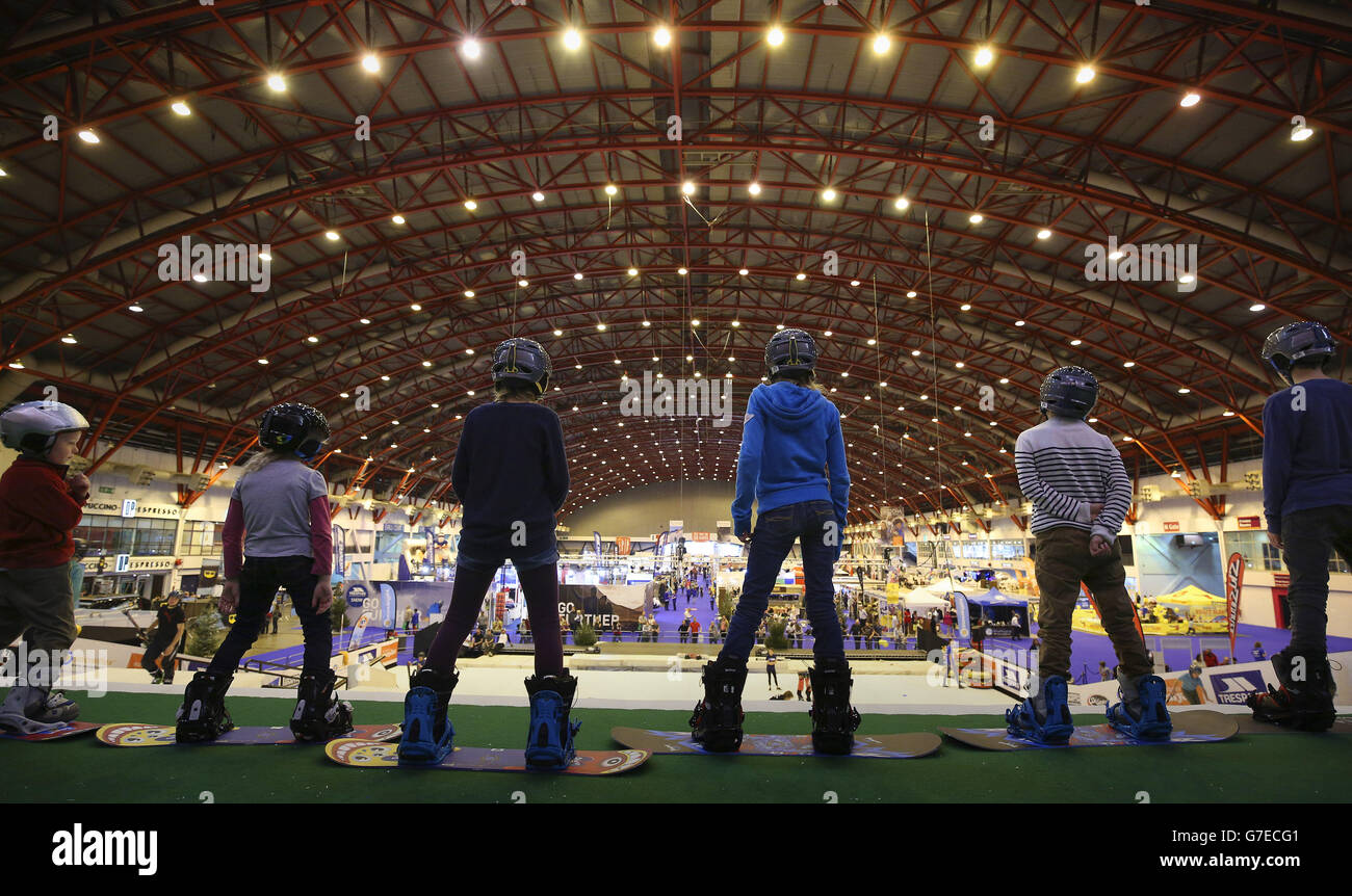 Children having a snowboard lesson on the dry ski slope at the Ski and