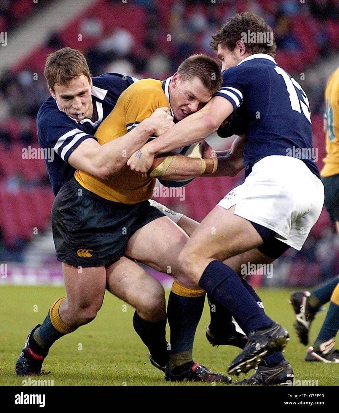 Clyde Rathbone Rugby Australia's Clyde Rathbone (centre) is tackled by Scotland's Andy ...