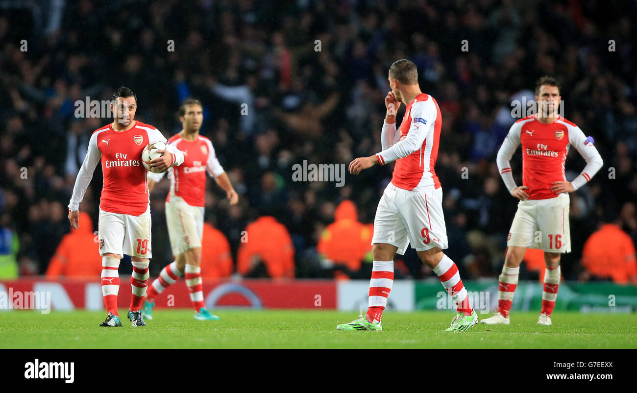 Arsenal's Santi Cazorla (left) and Lukas Podolski (right) dejected after Anderlecht score during the UEFA Champions League Group D match at Emirates Stadium, London. PRESS ASSOCIATION Photo. Picture date: Tuesday November 4, 2014. See PA story SOCCER Arsenal. Photo credit should read Nick Potts/PA Wire. Stock Photo