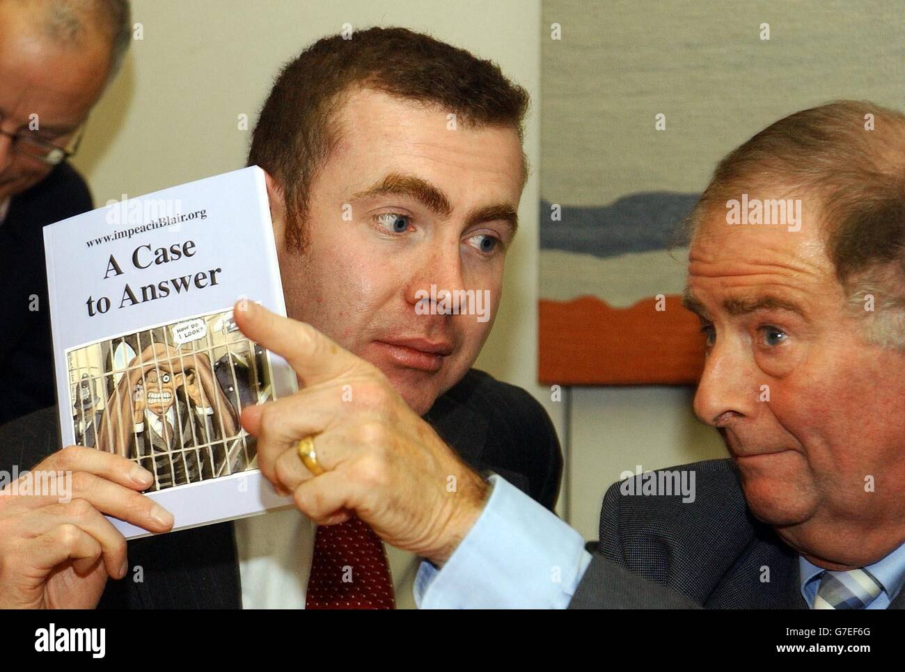 Adam Price (left) of Plaid Cymru with Roger Gale MP holding copies of 'A case to answer' the report on the Prime Ministers coduct in the war against Iraq, during a press conference, where celebrity anti-war campaigners and MP's called for Tony Blair's impeachment. Some 23 MPs have signed a Commons motion calling for the Prime Minister to be thrown out of office for 'gross misconduct'. Author Iain Banks, playwright Harold Pinter and musician Brian Eno are due to join them for a photocall in Parliament. Stock Photo