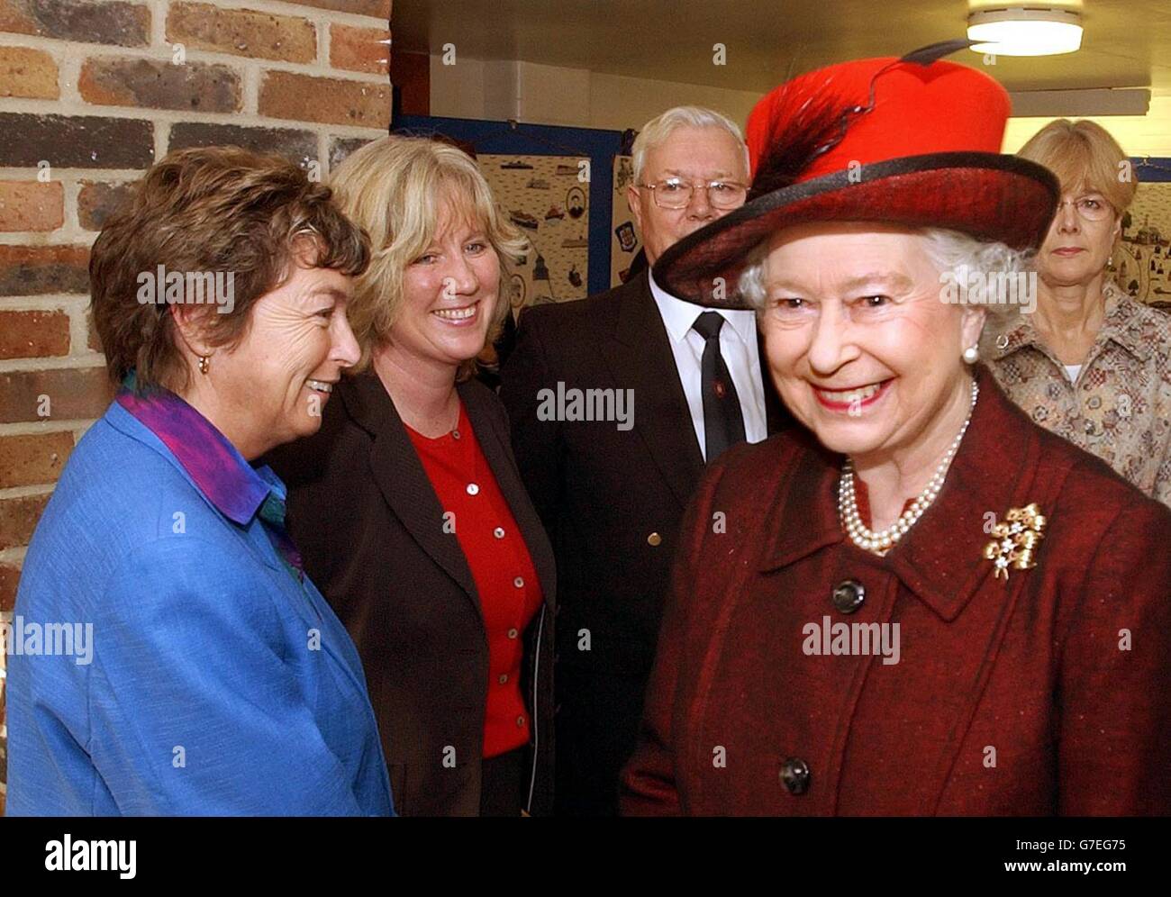 The Queen smiles as she turns away from Jacky Froggatt (left) the Headmistress of Harwich School, in Harwich, Essex. Stock Photo