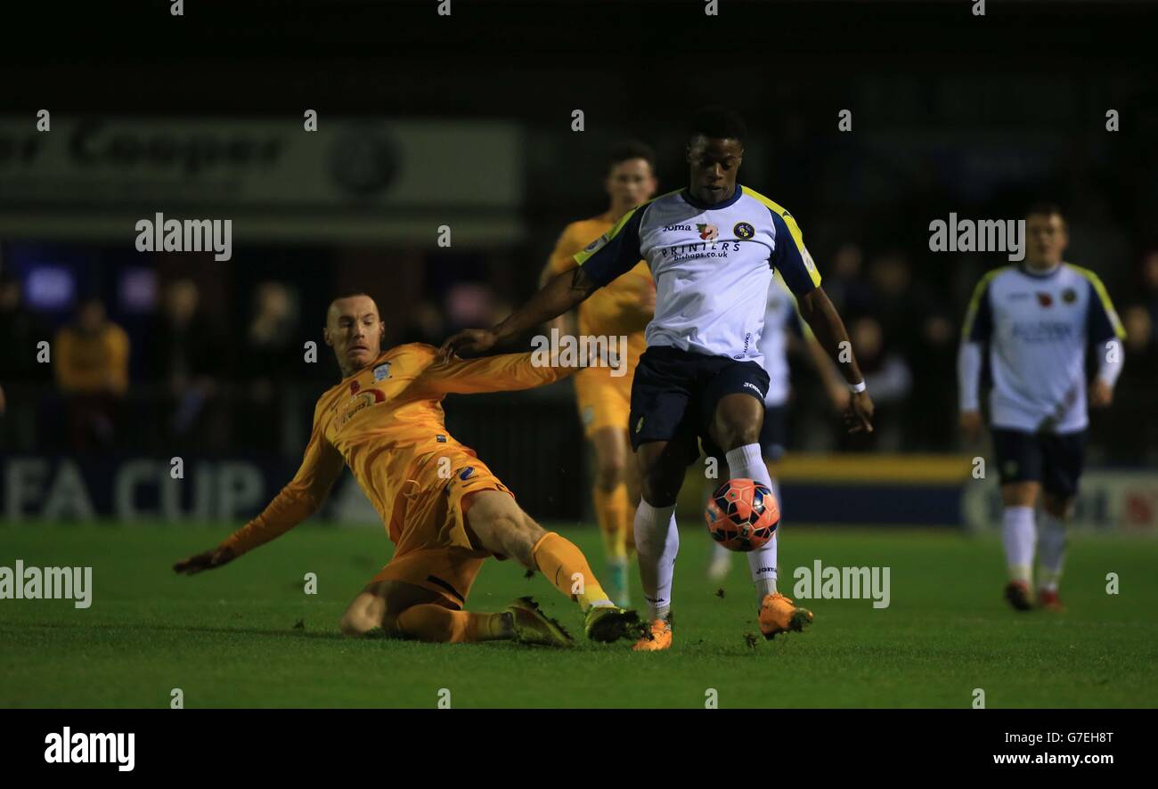 Havant & Waterlooville JJ Hooper runs past the tackle from Preston North End's Jack King during the FA Cup First Round match at West Leigh Park, Havant. Stock Photo