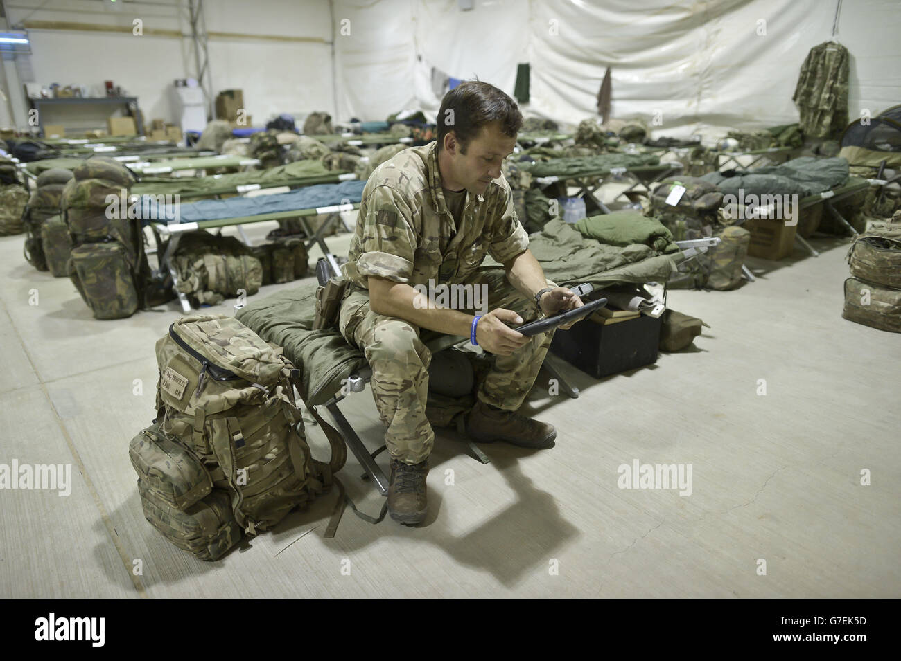 Staff Sergent Craig Worsley, 34, from Swansea, of 1st The Queen's Dragoon Guards, sits inside temporary tented accommodation at Camp Bastion, as troops prepare to withdraw from the camp in Helmand Province, Afghanistan and return to the UK. Stock Photo