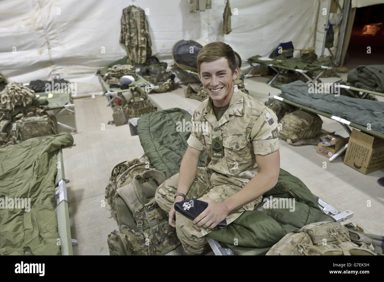 Corporal Thomas Warner 23, from Port Talbot of 1st The Queen's Dragoon Guards, sits inside temporary tented accommodation at Camp Bastion, as troops prepare to withdraw from the camp in Helmand Province, Afghanistan and return to the UK. Stock Photo