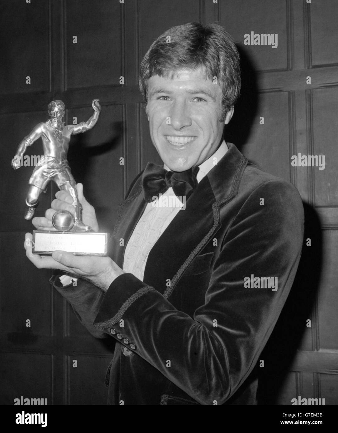 Emlyn Hughes, the Liverpool captain elected footballer of the year by the Football Writers Association, at the Cafe Royal in London, after receiving his trophy from Helmut Schoen, the manager of World Champions, West Germany. *17/11/04: Football legends and former team-mates of Emlyn Hughes will join hundreds of mourners at the funeral of the Liverpool and England star. Hughes, 57, died from a brain tumour at his home in Sheffield a week ago. Stock Photo