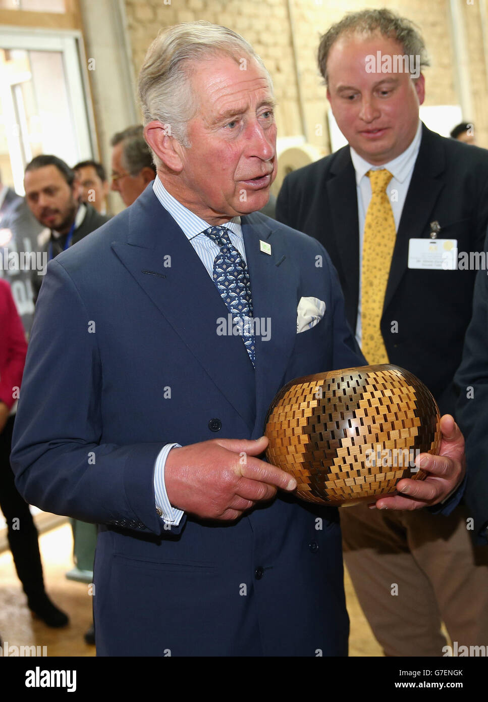 The Prince of Wales is presented a handmade gift during a woodwork workshop during a visit to a 'Skill School' in Bogota, on the second day of the Prince of Wales and Duchess of Cornwall's tour to Colombia and Mexico. Stock Photo